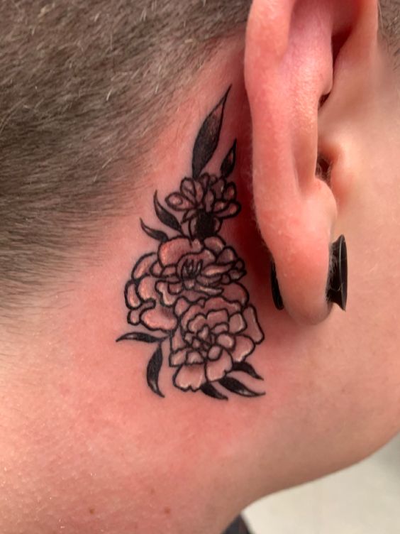 Small Ear Marigold tattoo