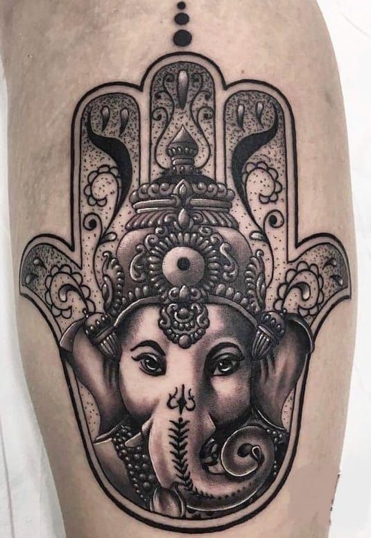 Intricate Hamsa calf tattoo design symbolizing protection and good fortune.