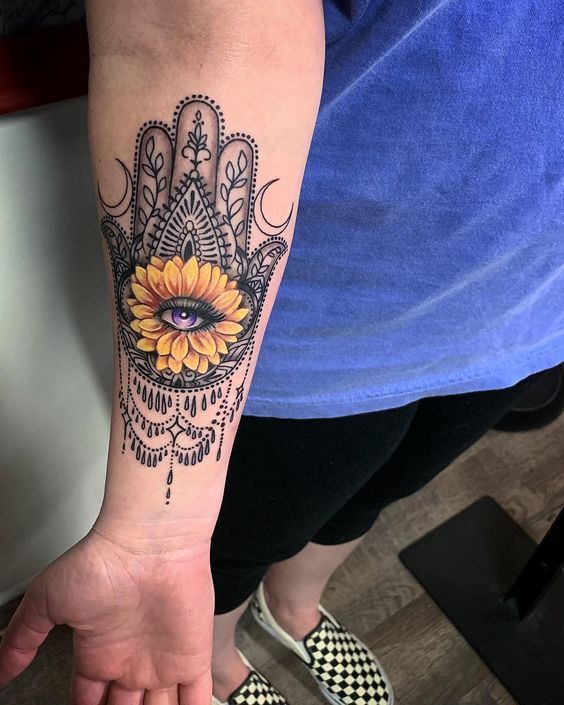 Stylized Hamsa forearm tattoo artwork, emphasizing the transformative power and mystical aura of the symbol.