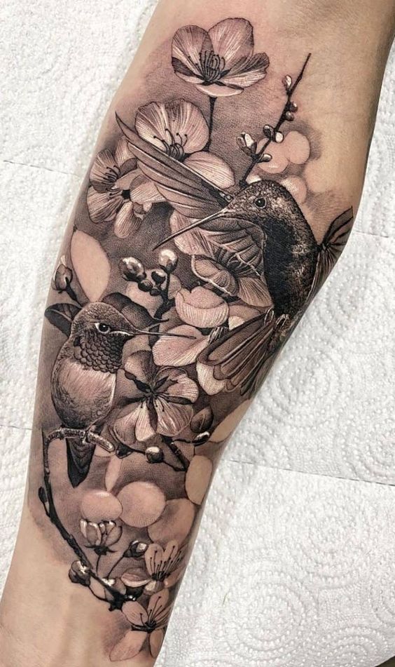 Black and gray hummingbird tattoo on the calf 