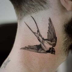Black and white Swallow tattoo on the neck
