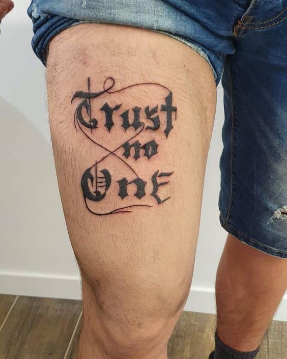 Trust No One thigh tattoo