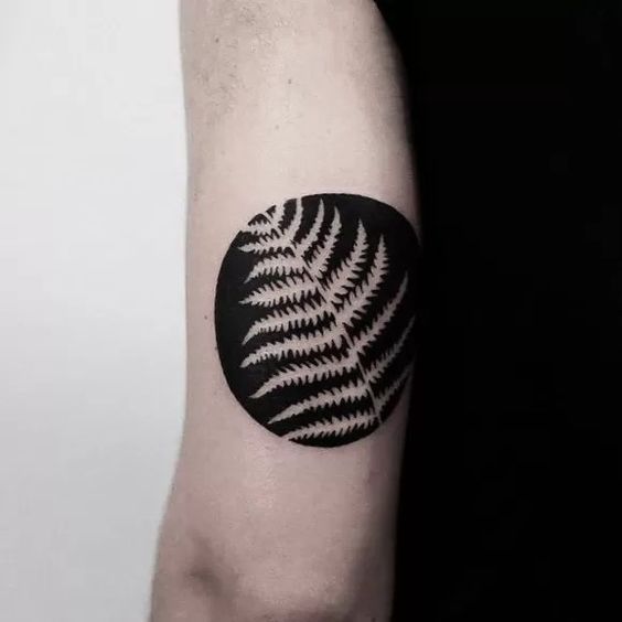 Bicep negative space tattoo