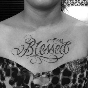 Blessed tattoo on the chest is a meaningful lettering tattoo 2