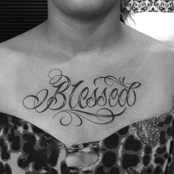 “Blessed” tattoo on the chest is a meaningful lettering tattoo