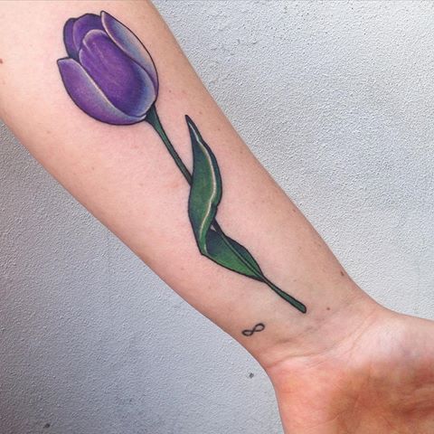 Purple tulip flower tattoo on forearm