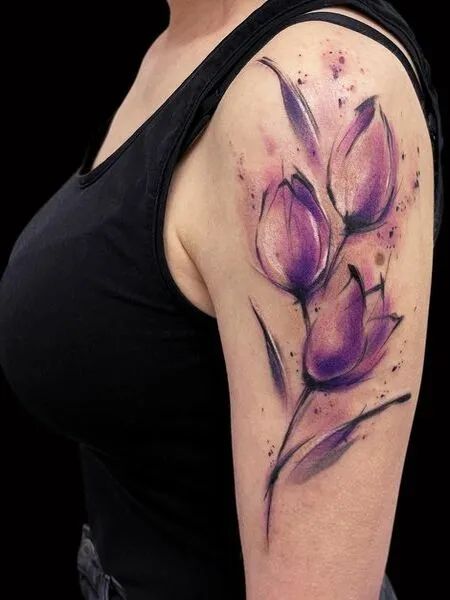 Purple tulip tattoo on the shoulder