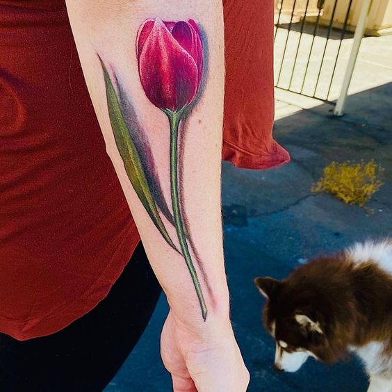 Pink tulip flower tattoo on forearm
