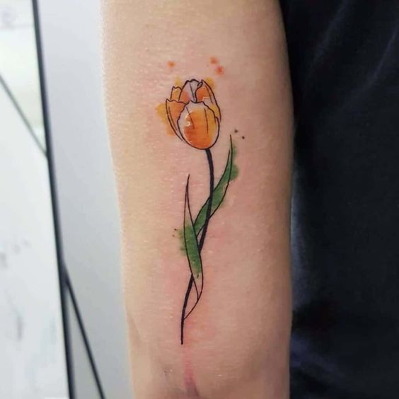 Yellow watercolor tulip flower tattoo on arm