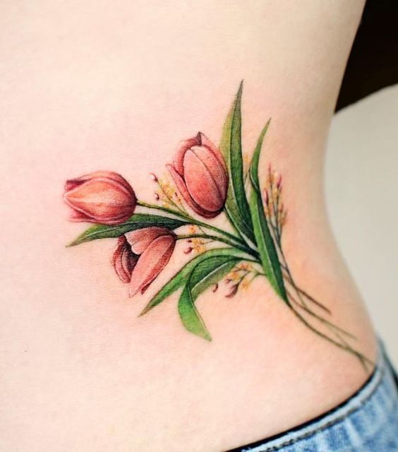 Red tulip flower tattoo on ribs