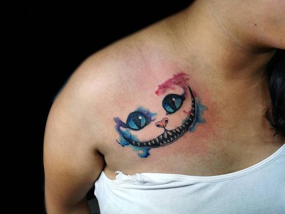 Cheshire cat smile tattoo on shoulder