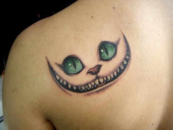 Cheshire cat smile tattoo on shoulder