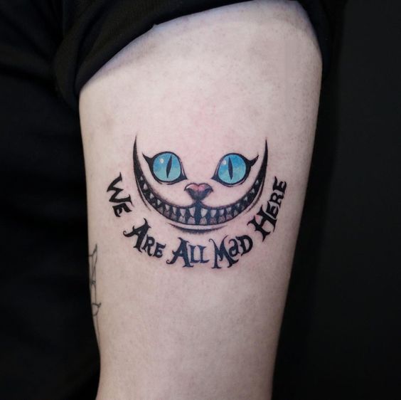 Cheshire cat tattoo with Quotes or Phrases on shoulder