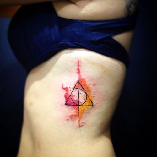 Watercolor ribs Deathly Hallows tattoos with a pop of colors 15