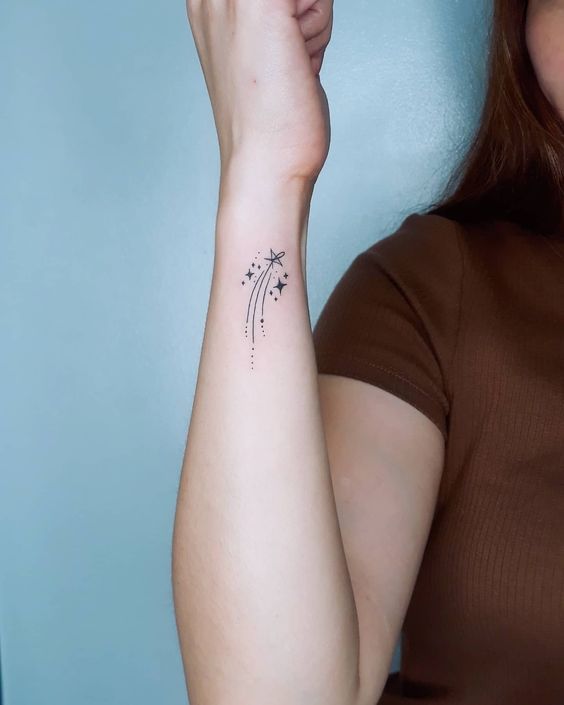 Falling star as elegant shooting star tattoo on wrist