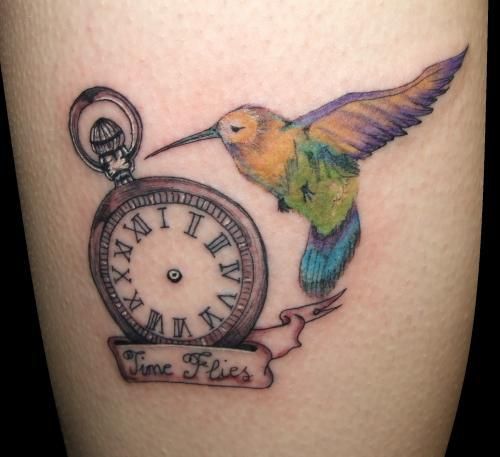 Clock without pointers with bird tattoo 