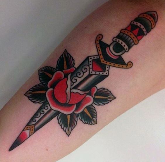 Rose Pierced by a Dagger Tattoo on forearm