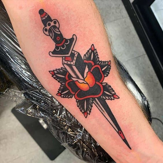 Forearm Rose Pierced by a Dagger Tattoo