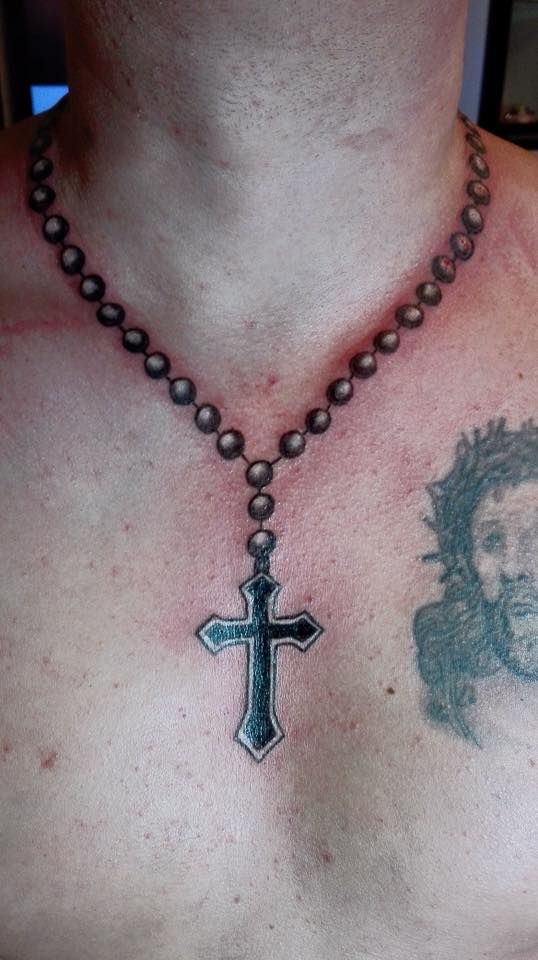 Cross on the chest tattoo