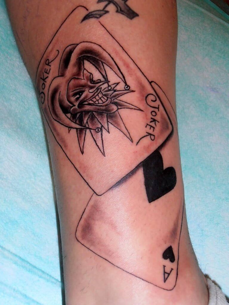 Striking Joker card calf tattoo design representing the themes of risk, rebellion, and the unpredictable nature of the Joker.