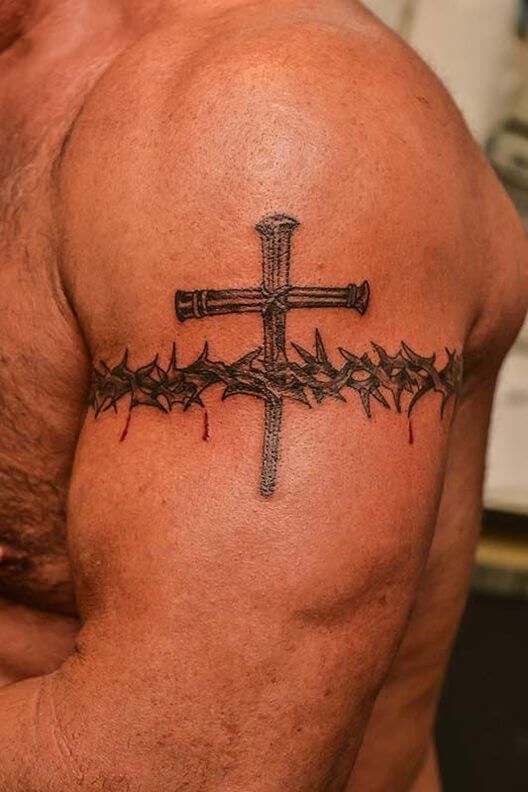 Bold bicep Crown of Thorns tattoo with across design symbolizing the trials and tribulations of life